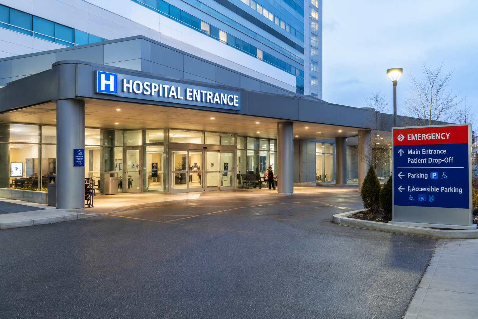Modern hospital entrance with emergency department access, patient drop-off area, and healthcare facility security environment